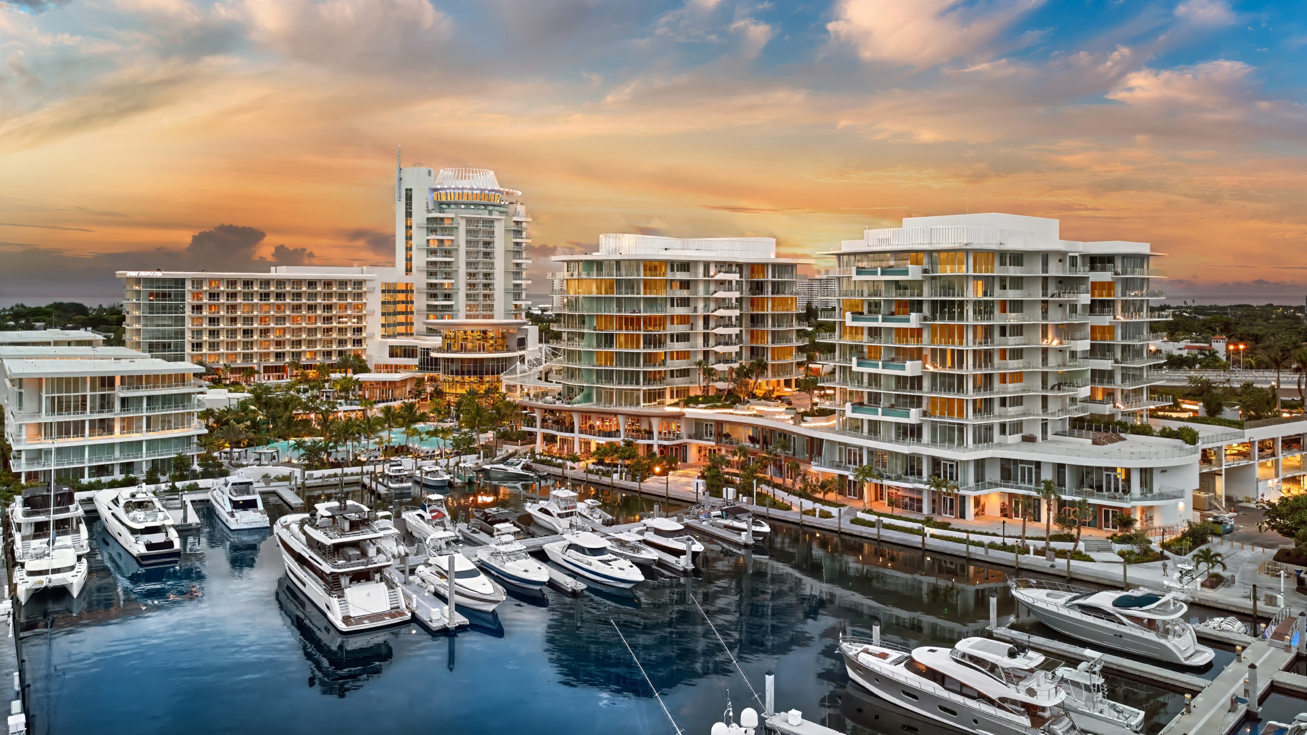The whole harbor at dusk: hotel, crown, Azul, Indigo and a marina full of yachts