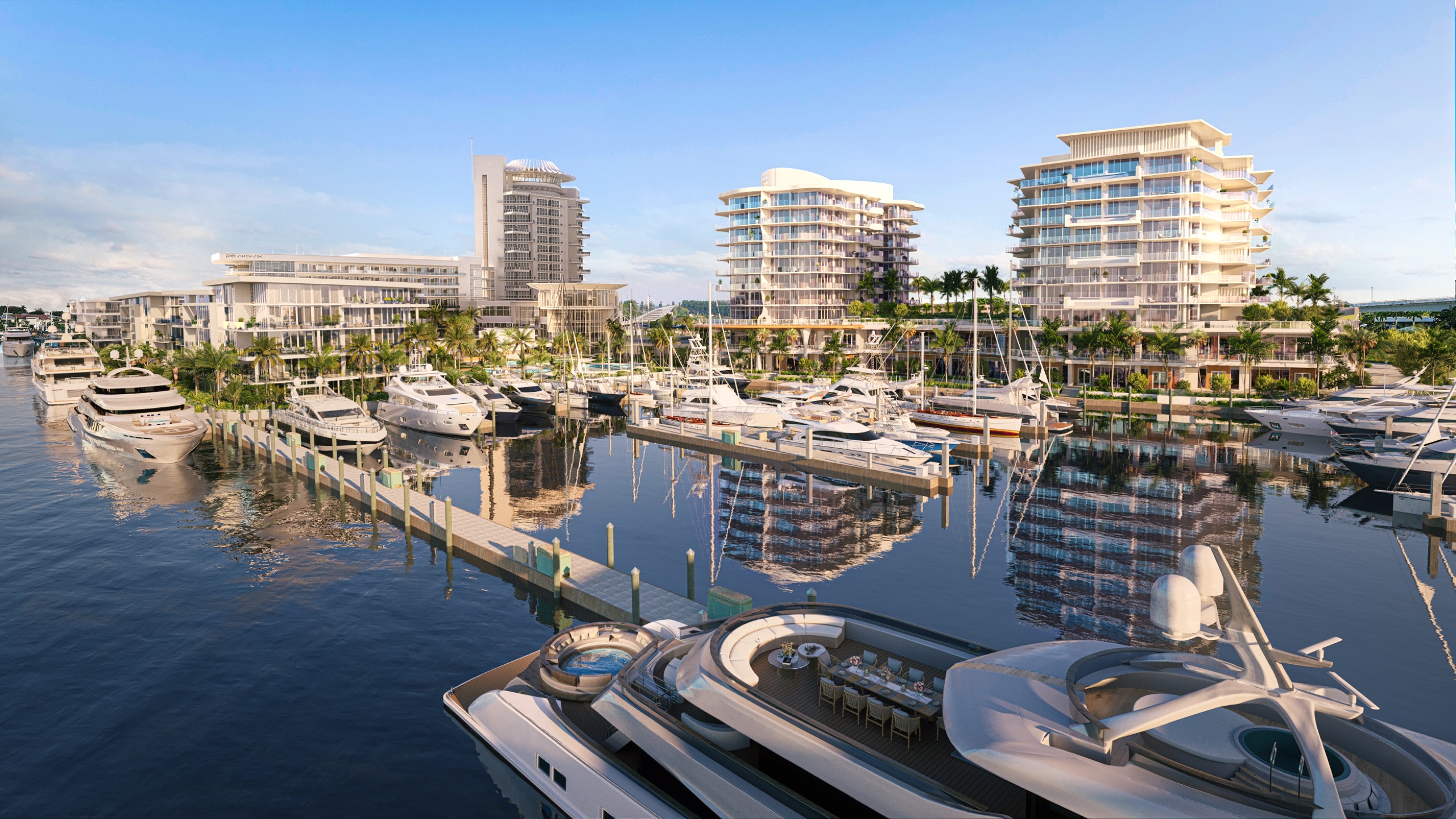 Morning gold over the property: the spire-crowned tower, the two residential towers and the full marina