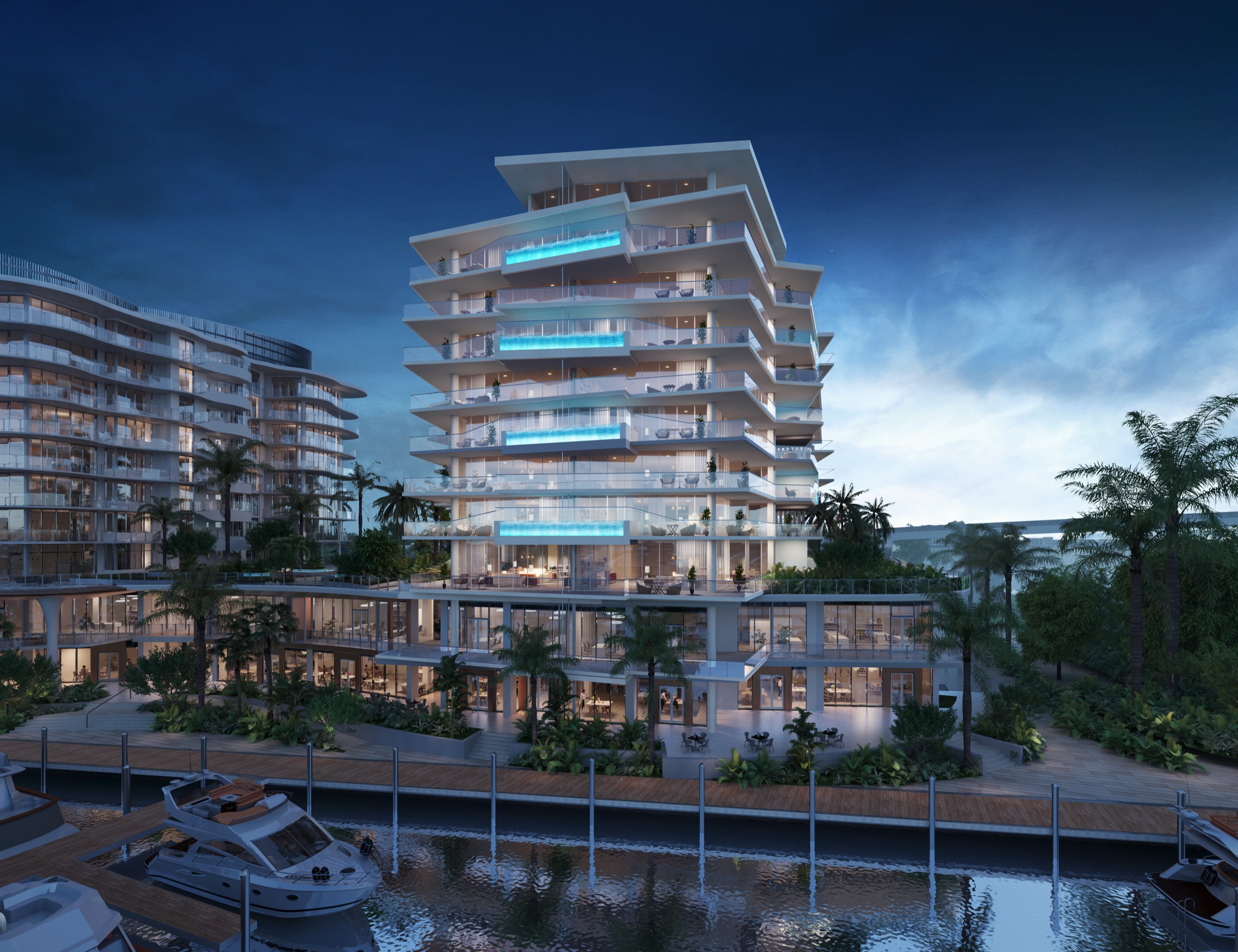 Indigo at dusk from the marina walk, terrace pools lit above the restaurants